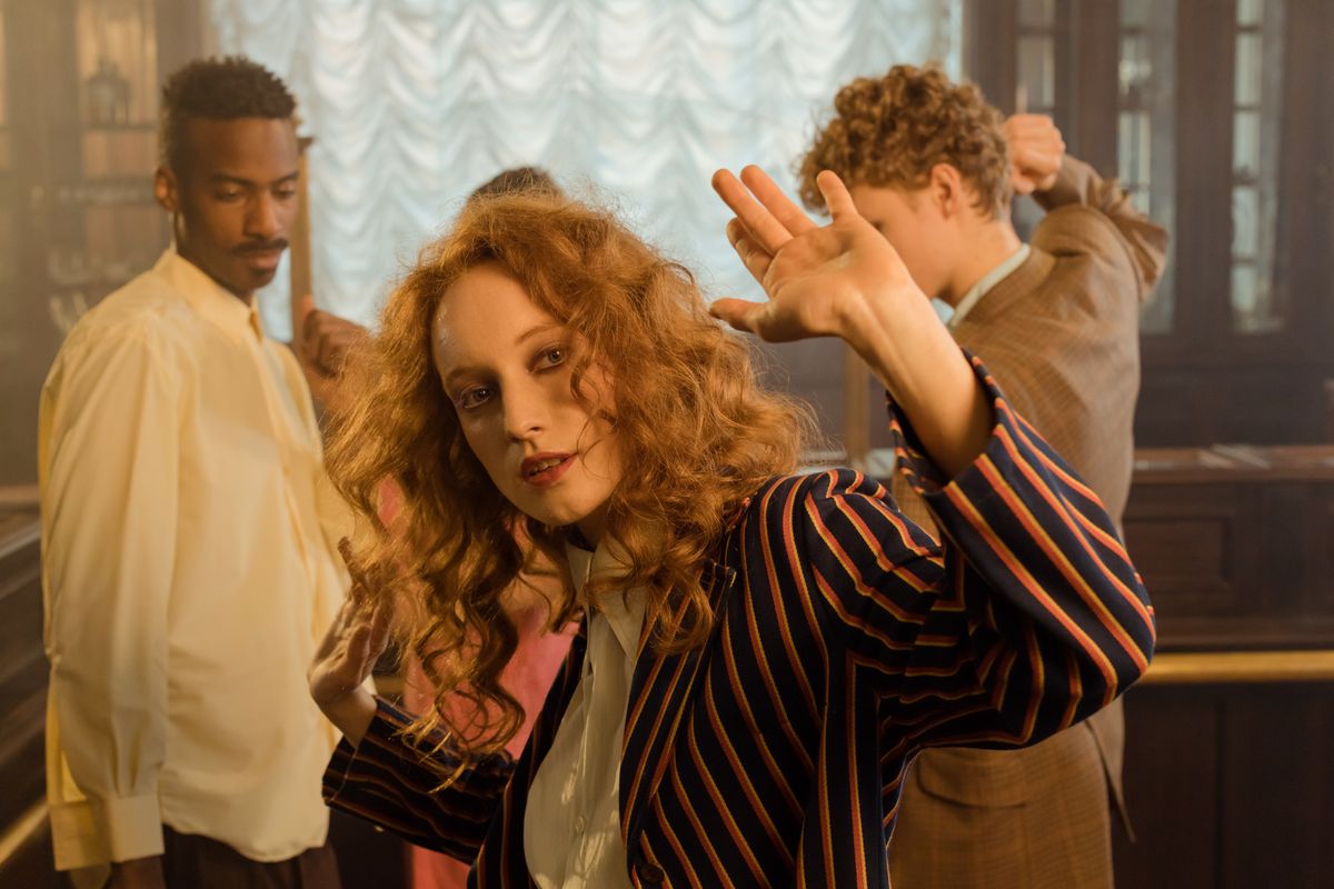 Retro dressed friends dancing together at a throwback party