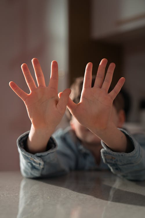 Close-Up Shot of a Boy Showing His Palms