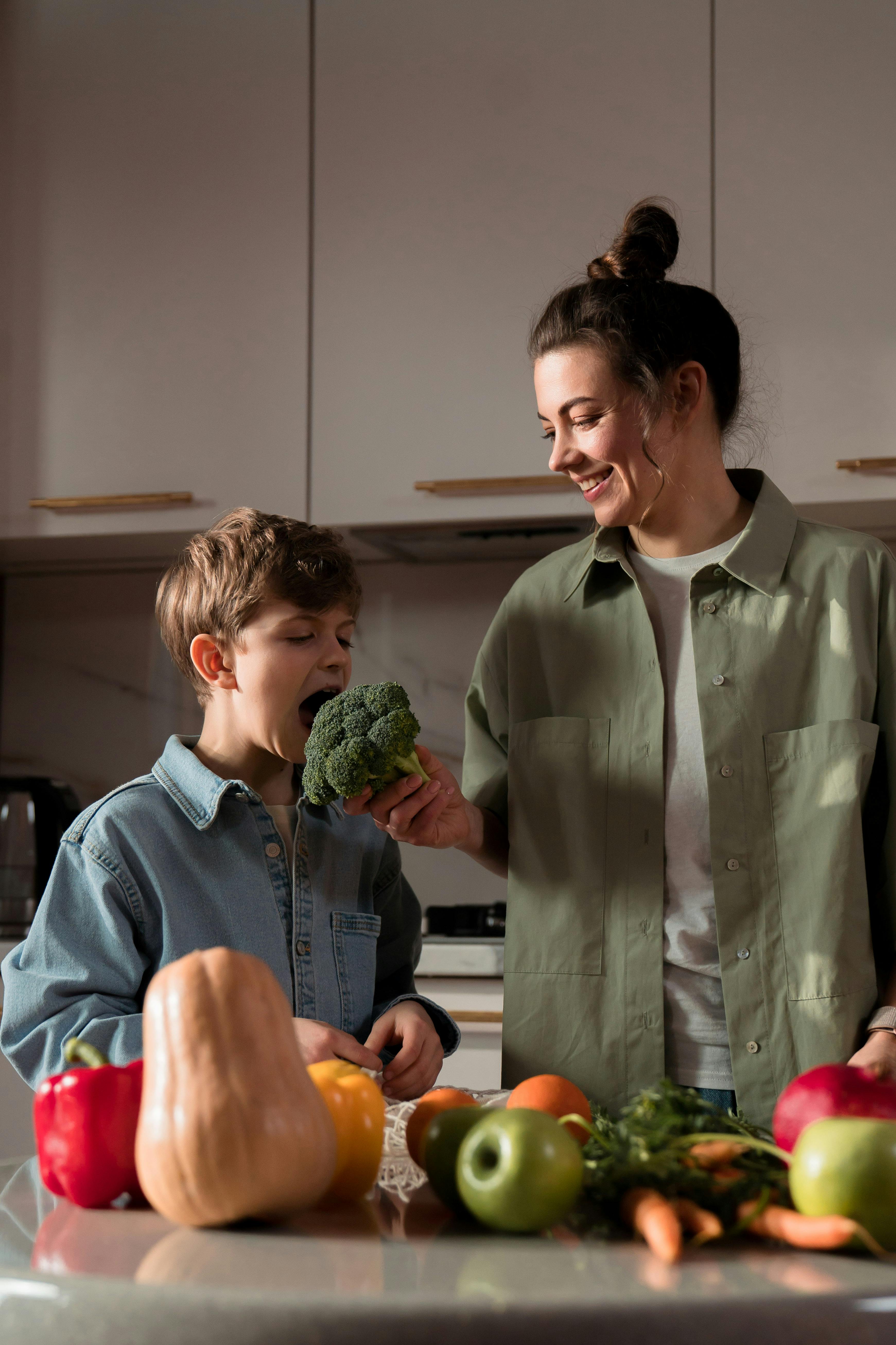 a mother and her children unpacking goods in the kitchen