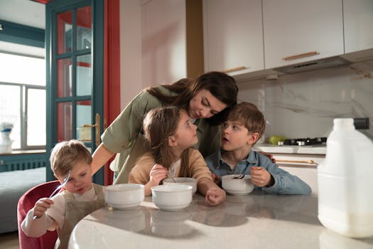A mother and her children enjoy breakfast together in a cozy kitchen setting.