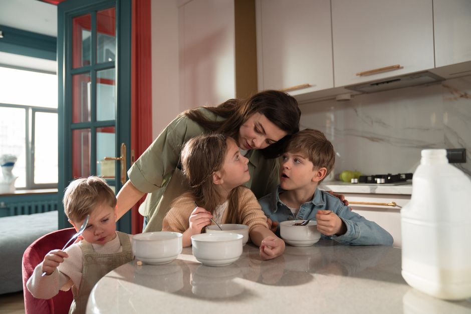 Photo by Ron Lach on Pexels A mother and her children enjoy breakfast together in a cozy kitchen setting. - Photo by Ron Lach on Pexels