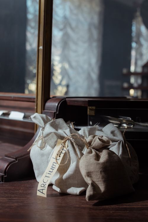 Free Close-up of vintage fabric sacks on a wooden countertop in warm lighting. Stock Photo
