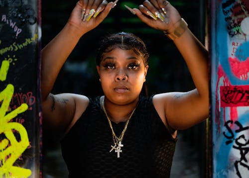 Woman in a Black Tank Top Wearing Gold Necklaces