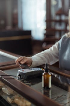 Customer using contactless payment at a vintage store counter with old-fashioned decor.