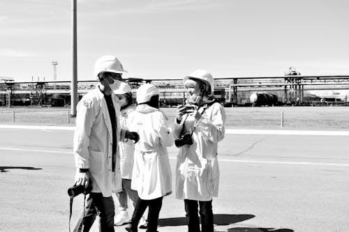 Free Grayscale Photograph of People with Cameras Wearing Coats Stock Photo