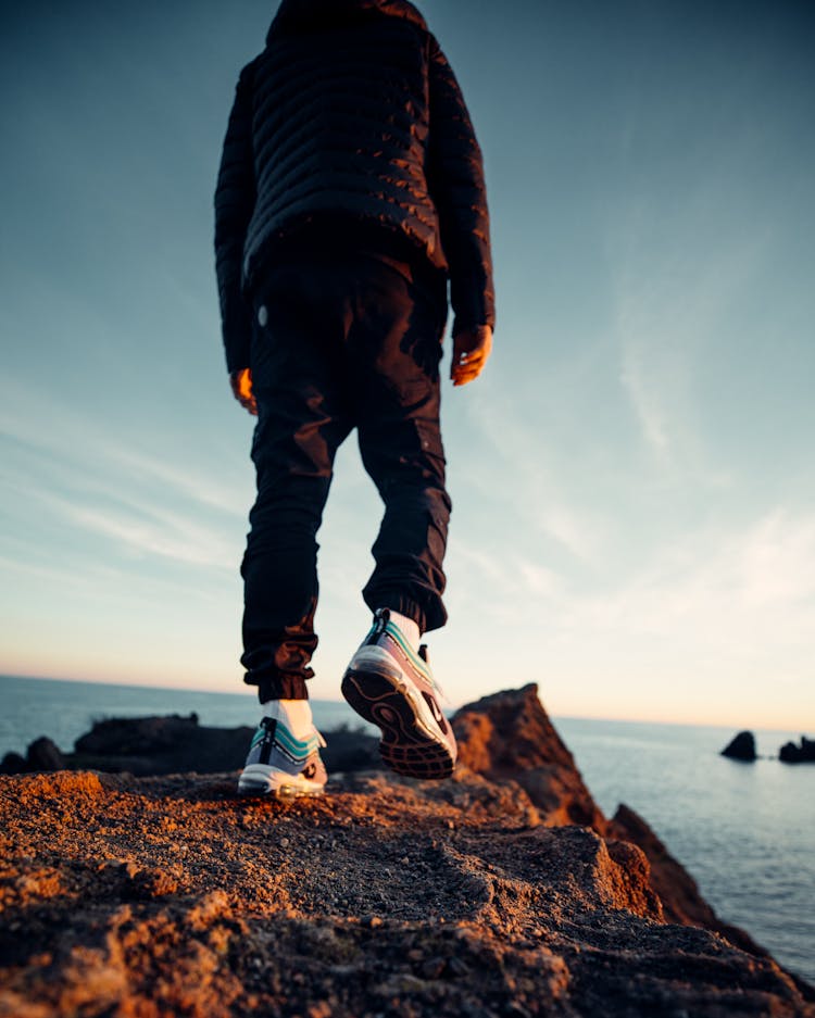 Man Hiking On A Rocky Seaside Path 