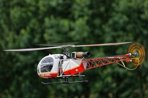 Free Photo of a Red and White Radio-Controlled Helicopter Stock Photo