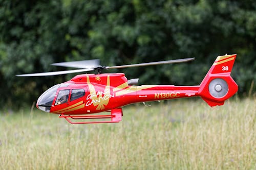 Free Photo of a Gold and Red Radio-Controlled Helicopter Stock Photo