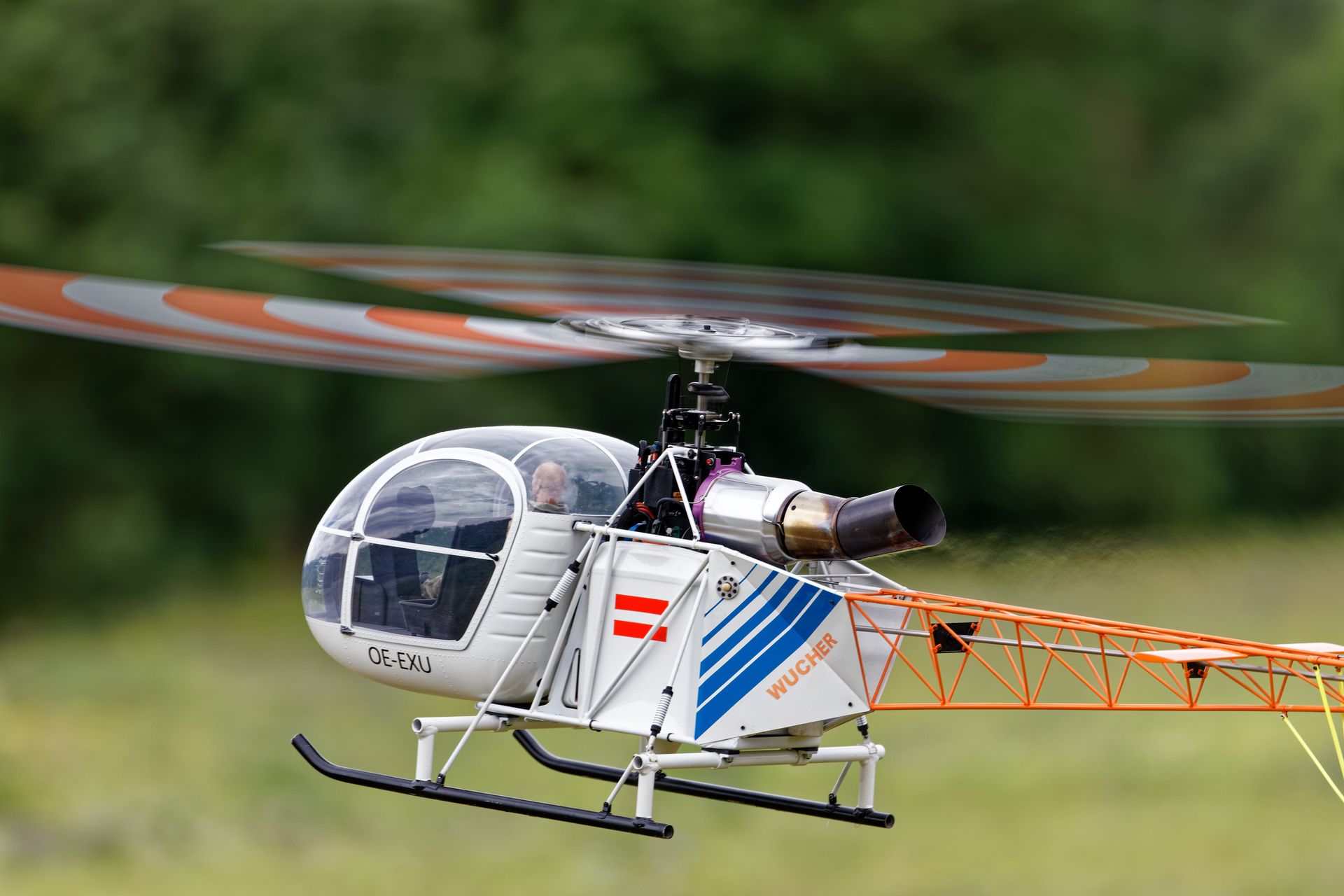 Close-up of a detailed radio controlled helicopter in flight, showing propellers and design.