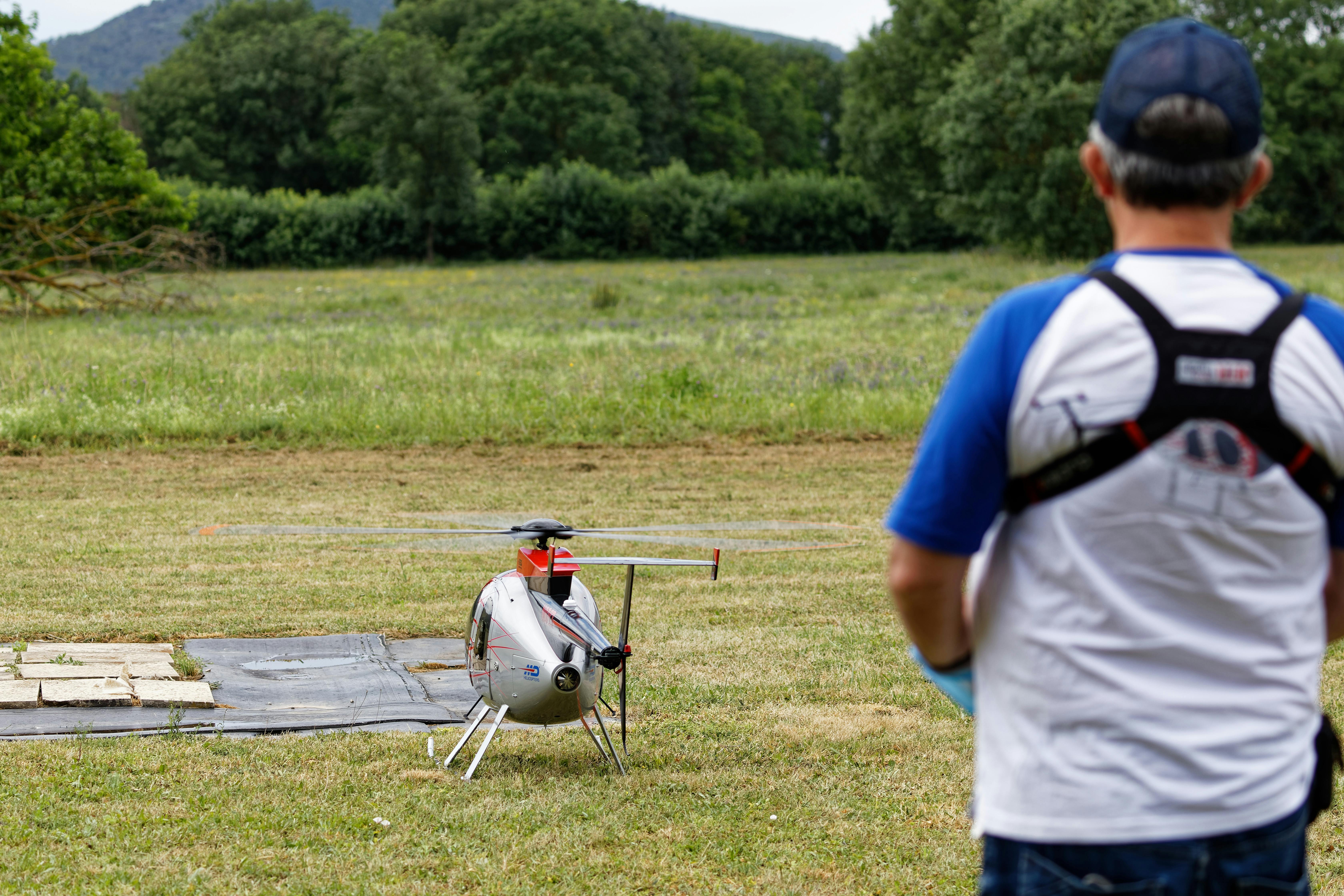 man flying a remotely controlled helicopter