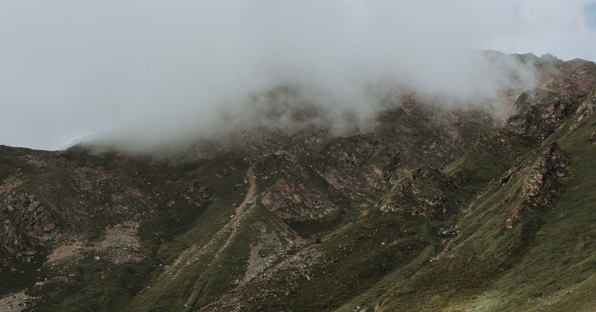 Mist rolling across a mountain range at dawn
