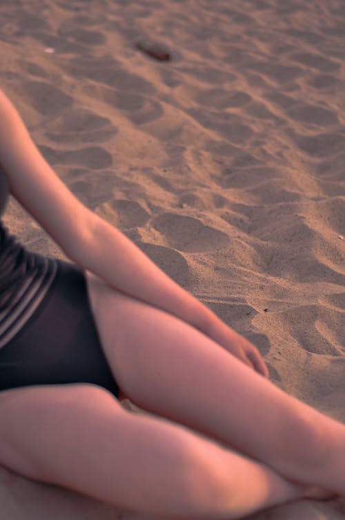 Woman in Swimsuit Sitting on the Sand