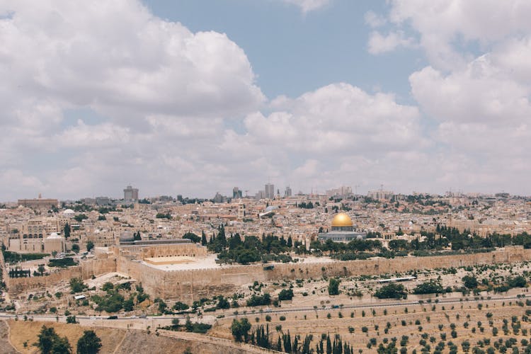 Cityscape With Beige Surrounding Walls And A Gold Dome