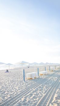 Peaceful beach scene in Kaliningrad, Russia, with white sand and umbrellas.
