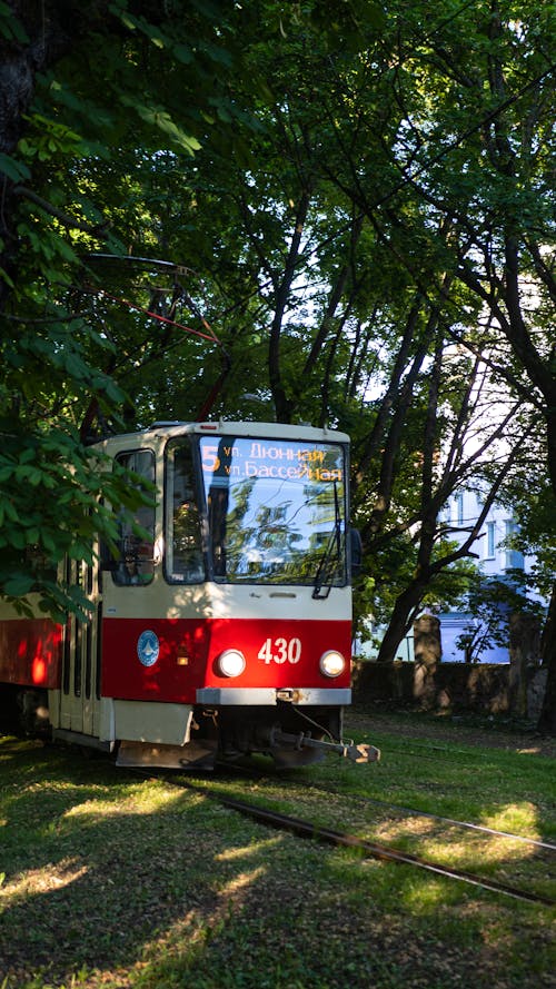 A Red and White Train on a Railroad 