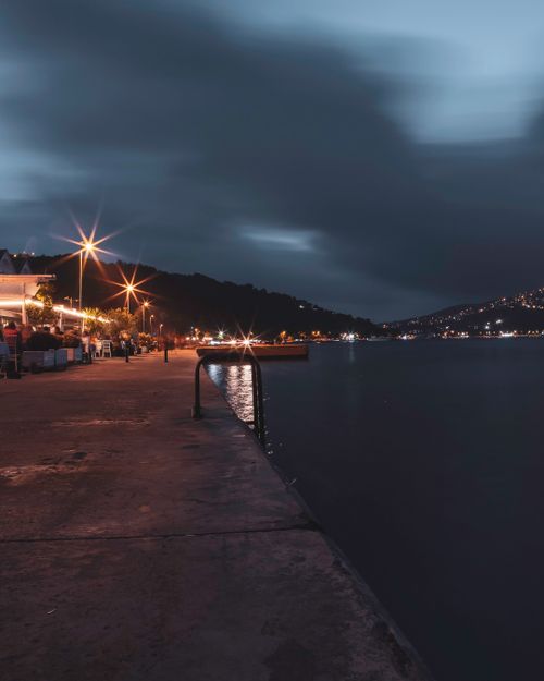 Free Beautiful nighttime view of Sarıyer waterfront in İstanbul, Turkey, under cloudy sky. Stock Photo