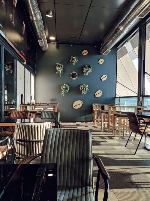 Free Stylish indoor cafe with modern decor and seating, perfect for socializing. Stock Photo