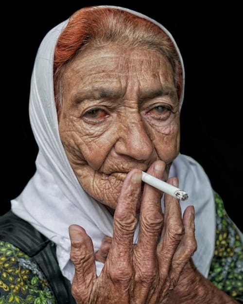 Portrait of an Elderly Woman Smoking a Cigarette