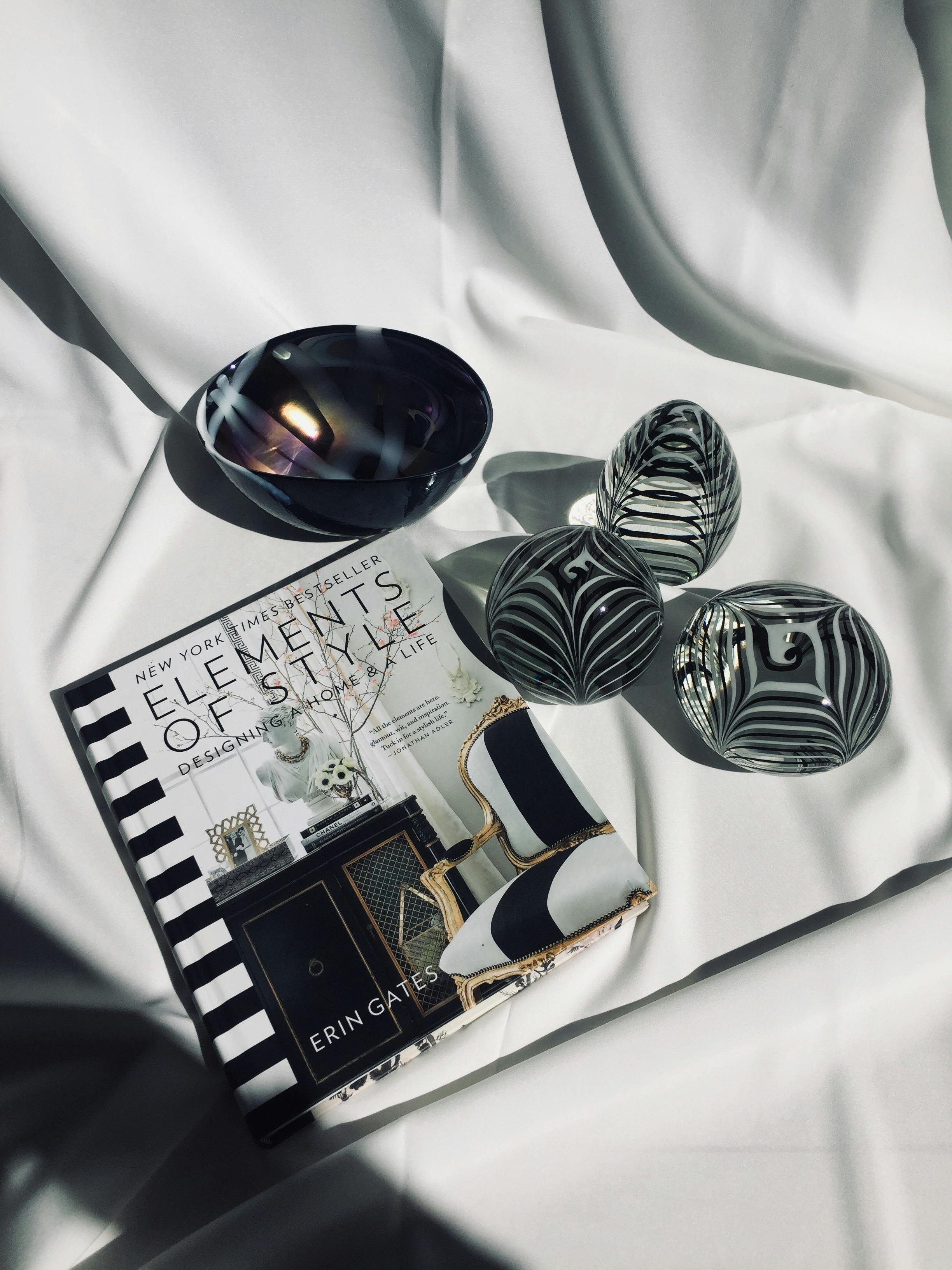 Black and White Magazine on White Cloth · Free Stock Photo