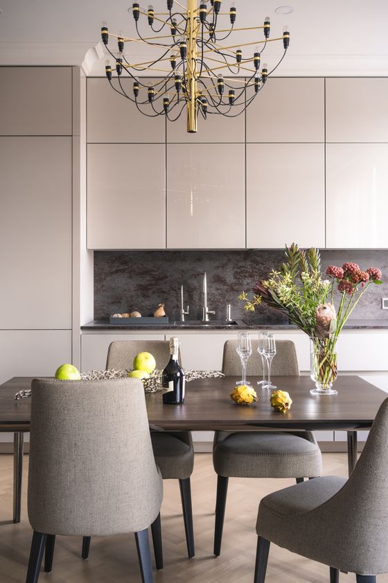 Dining area with wooden table and upholstered chairs — photo by Yura Forrat on Pexels