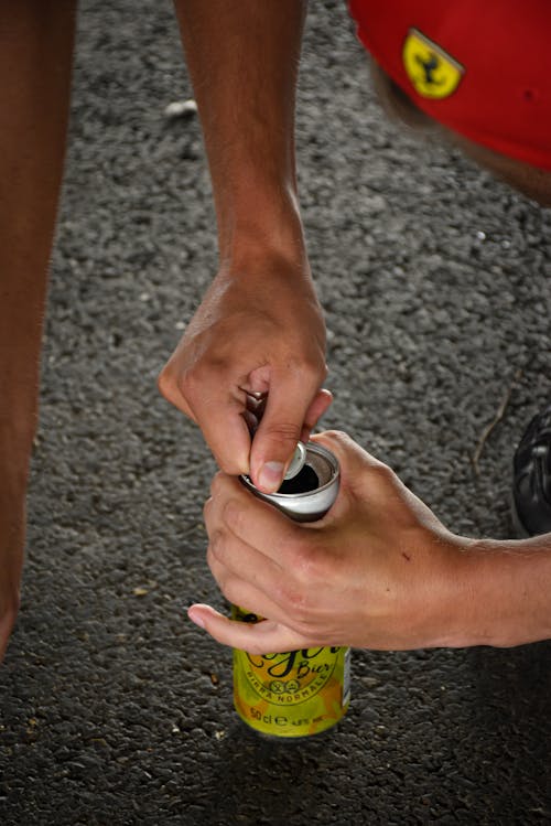 Person Holding a Canned Drink