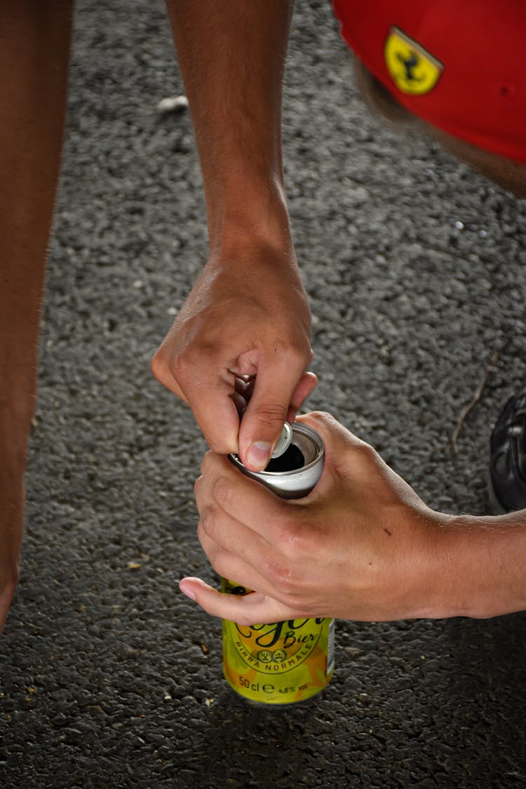 Person Holding A Canned Drink