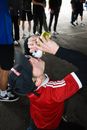 Man in Red Shirt chugging Beverage