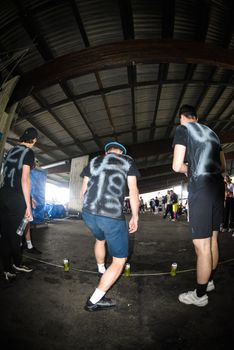 Men playing a street game under a large industrial roof setting with a focus on teamwork and competition.