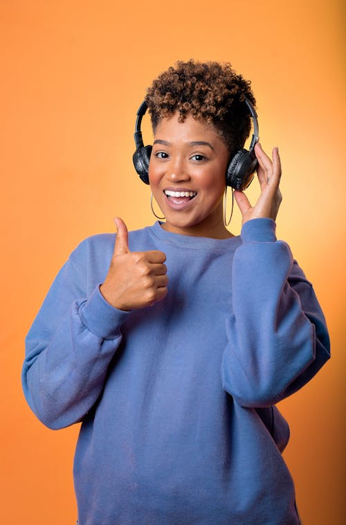 Woman in Blue Sweater wearing Black Headset