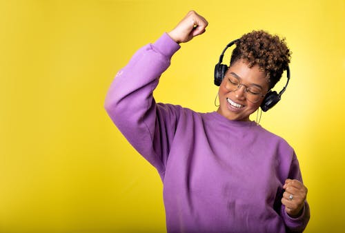 Photo of a Woman Dancing while Listening to Music