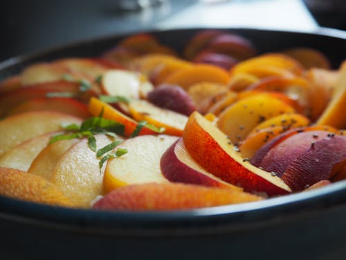 Sliced Fruits on Black Ceramic Bowl