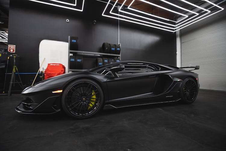 A Black Sports Car Parked Inside The Garage