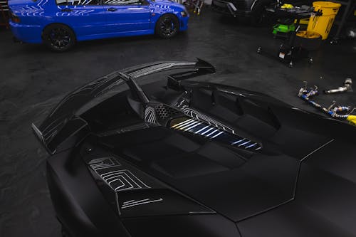 Black Lamborghini Aventador Parked Beside Blue Car