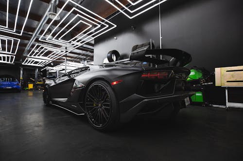 Black Lamborghini Aventador Parked on White and Black Staircase