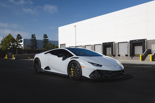 A White Lamborghini Sports Car Parked Outside