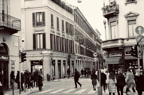 Free Black and white photo of a busy urban street corner with people walking in a bustling city environment. Stock Photo