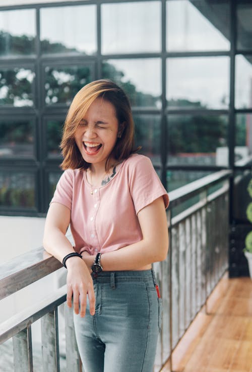 Free Photo of a Woman in a Pink Top Laughing Stock Photo