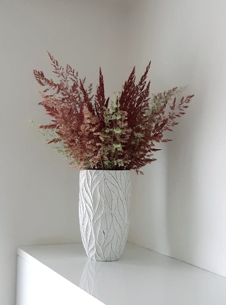 Flower Vase On White Wooden Sideboard