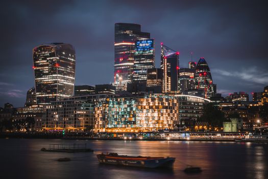 A breathtaking view of London's illuminated skyline at night featuring iconic skyscrapers.