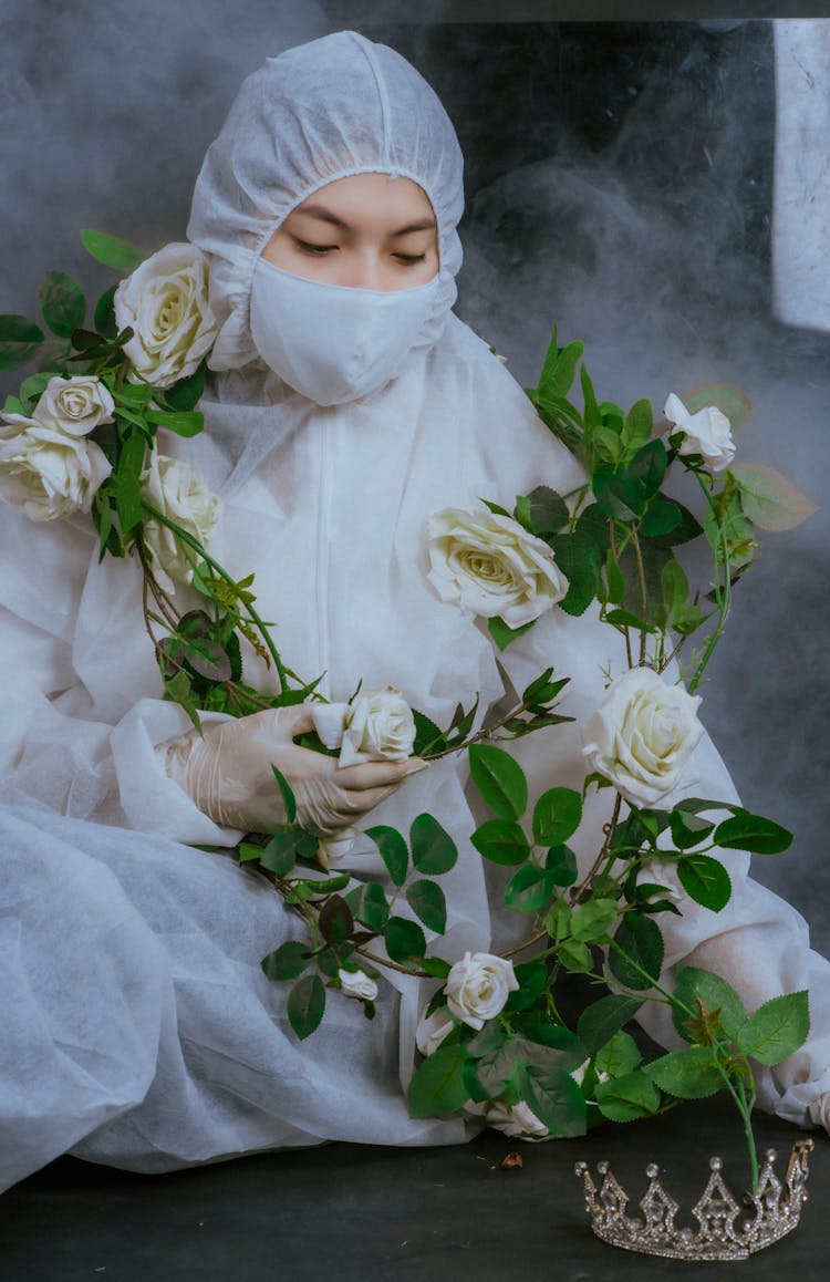 Person Wearing White Face Mask And Personal Protective Equipment