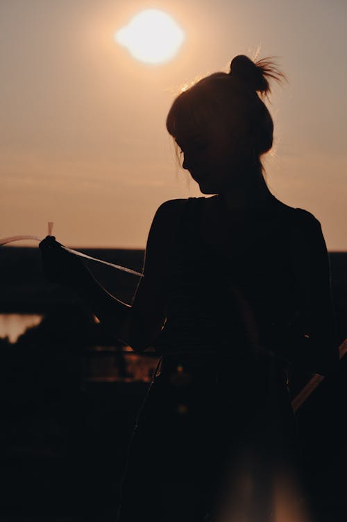 Silhouette of Woman in a Hair Bun