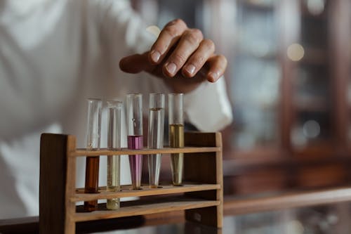 Person Holding Test Tubes