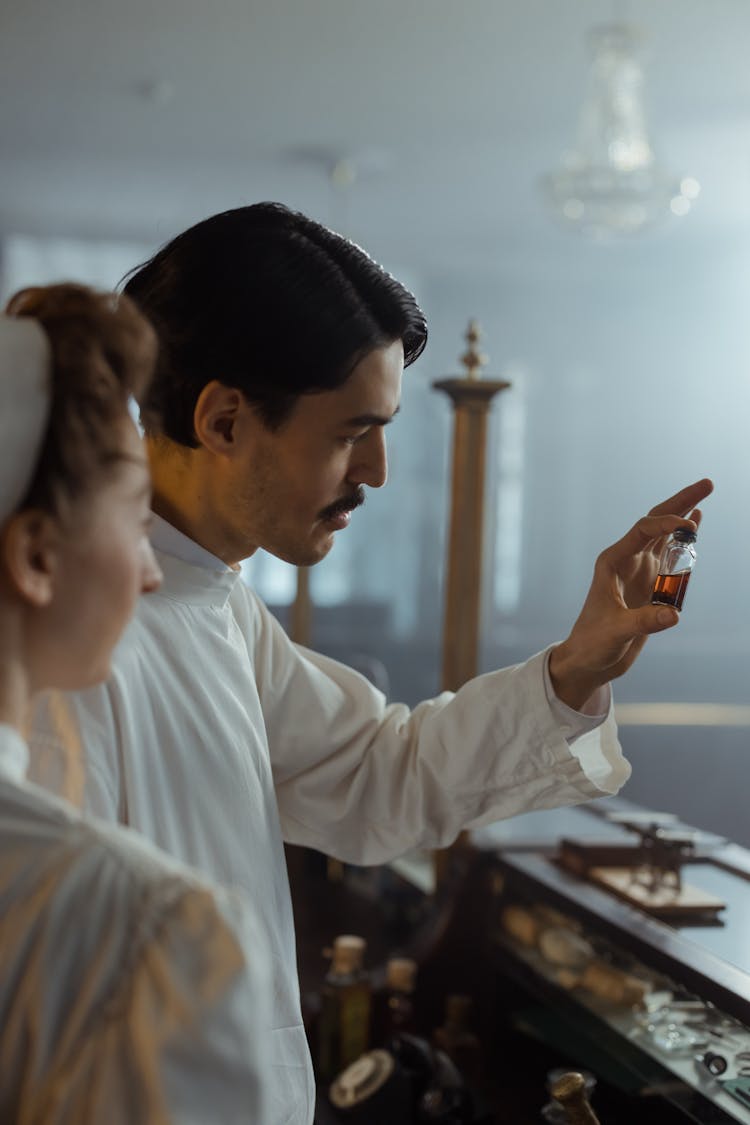 A Man Holding A Medicine Bottle