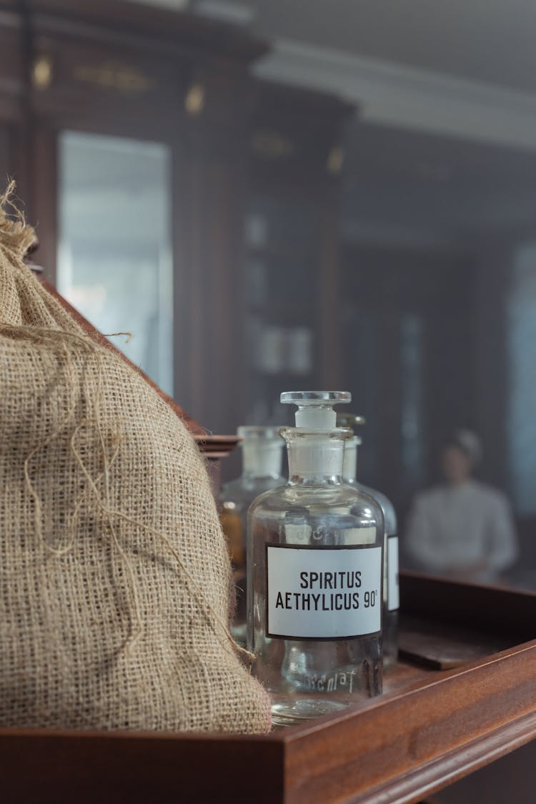 Clear Vintage Laboratory Bottle On Wooden Box