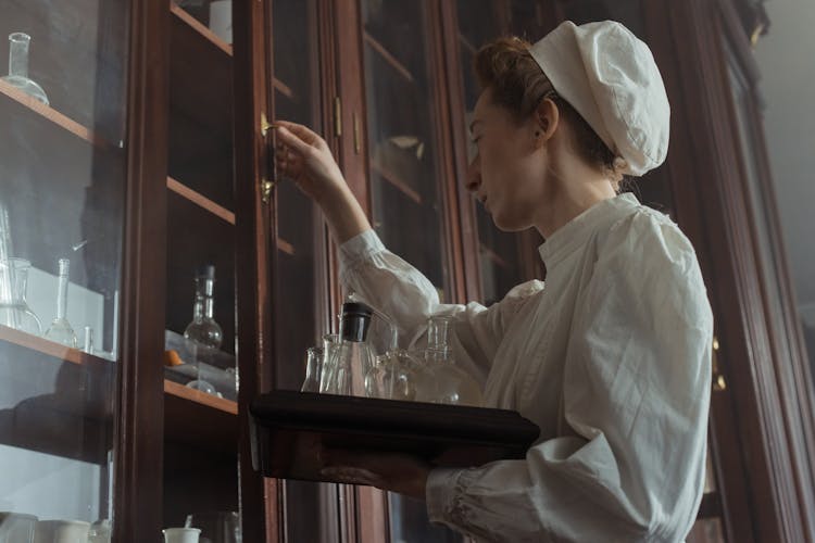 Low-Angle Shot Of A Woman Opening A Cabinet