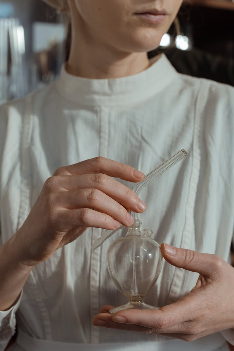 A Person's Hand Holding A Flask