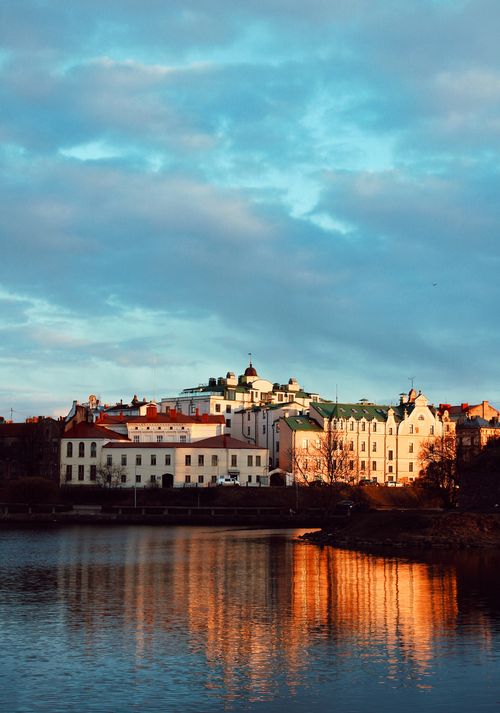 Free Captivating image of Vyborg's architecture reflecting in calm waters during a serene day. Stock Photo