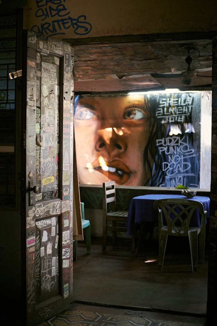 Dark Bar Interior And Large Poster With A Face