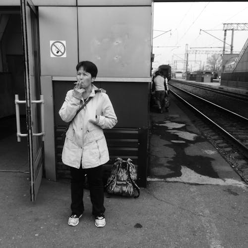 Free A Woman Smoking on the Railway Station Stock Photo