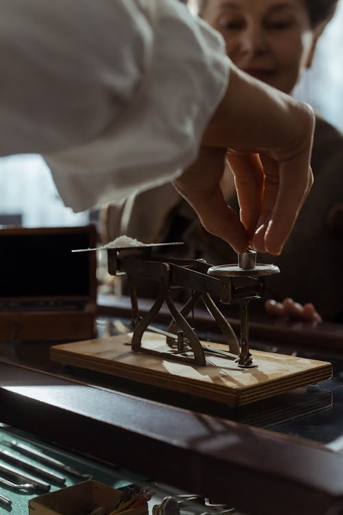 Person Using an Antique Weighing Scale